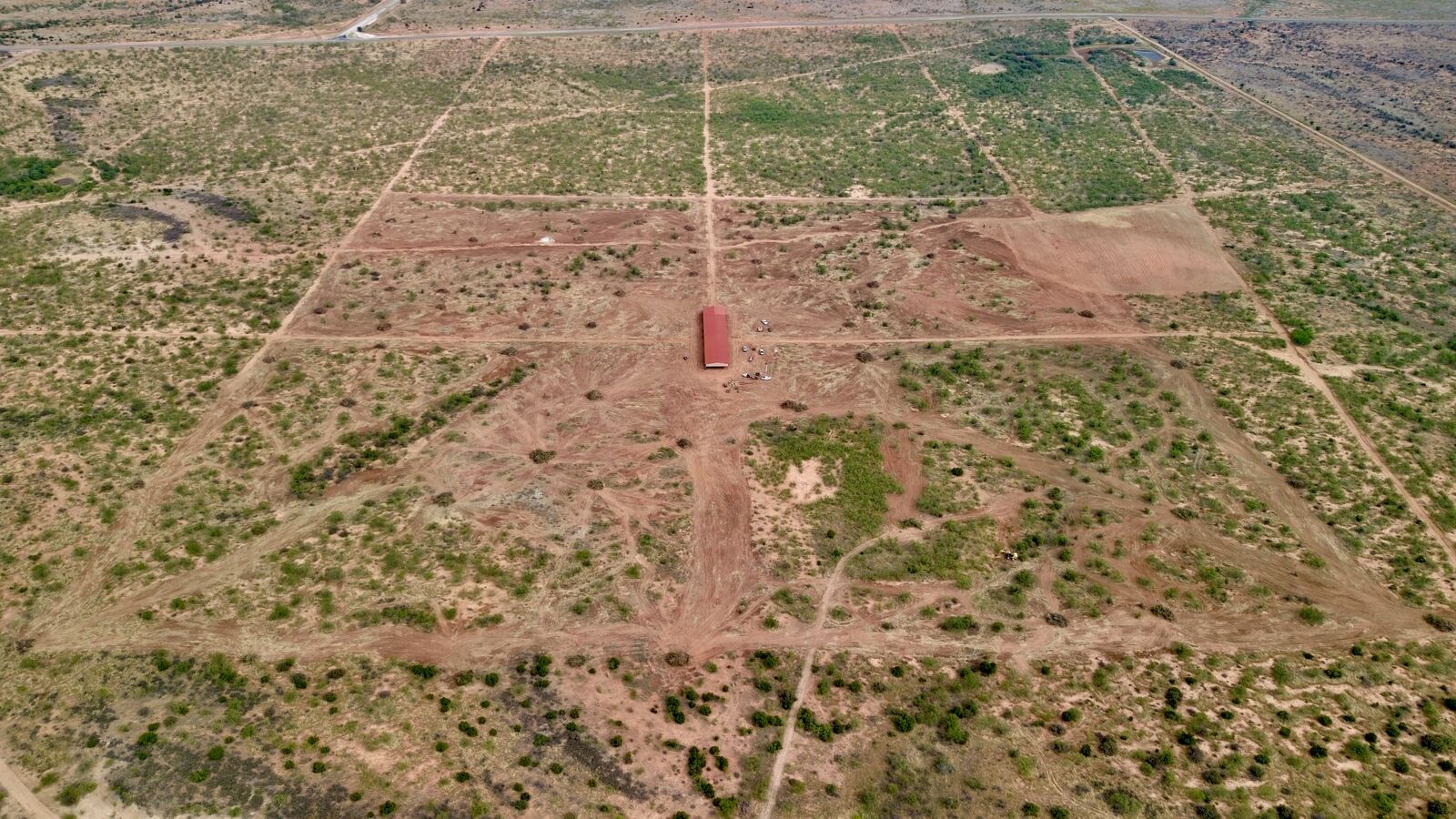 Aerial view of custom exotics traps with species-specific brush retention and cleared fence corridors on a private ranch in Kent County, Texas.